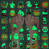 A collection of glow-in-the-dark Halloween temporary tattoos featuring various spooky characters and designs.