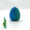 A vibrant blue dragon egg fidget toy with a textured, scale-like surface.