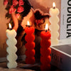 A set of two heart-shaped silicone candle molds, one white and one red, displayed next to lit candles.
