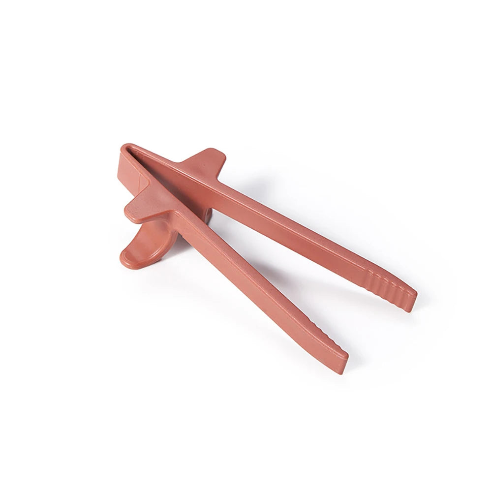 A pair of reusable pink wheat straw finger chopsticks shown against a white background.