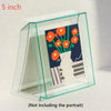 A clear acrylic photo frame displaying a floral arrangement on a dark blue background.