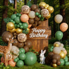 A balloon garland featuring earthy tones and olive greens with giraffe print accents set against a wooden backdrop.