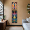A vertical tapestry featuring a colorful chakra design on a beige wall in a bedroom setting.