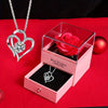 A pink box containing a red rose and a silver heart-shaped necklace gift set