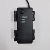 A black electronic timer device with three settings: 1 Timer, 2 On, and 3 Off.