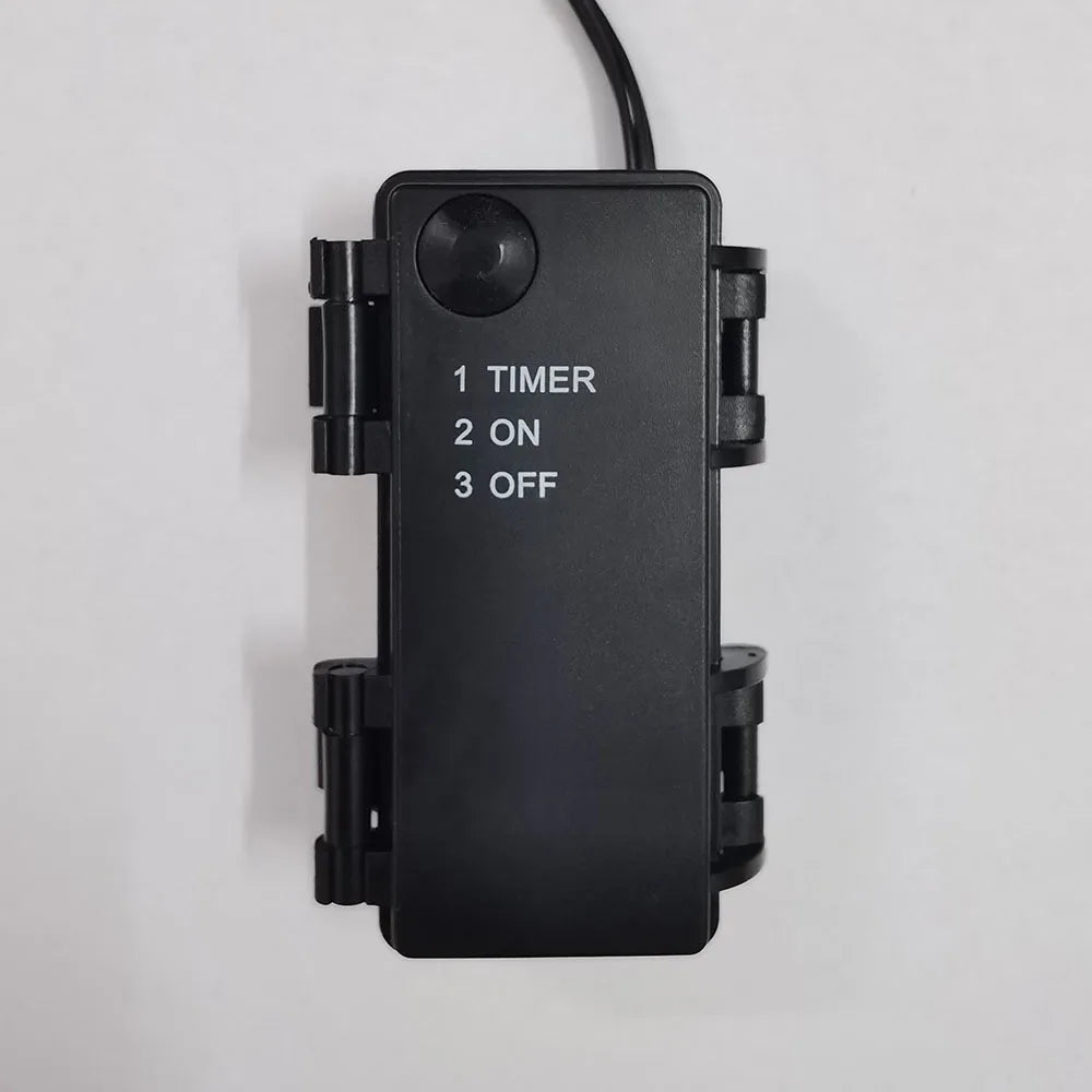 A black electronic timer device with three settings: 1 Timer, 2 On, and 3 Off.