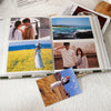 An open linen printed photo album displaying various landscape and portrait photographs.
