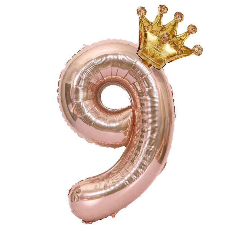 Rose gold foil balloon shaped like the number 9 with a gold crown topper