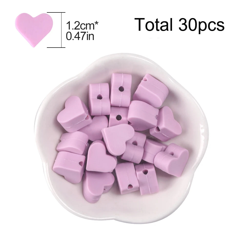 A pile of 30 pink silicone heart beads is displayed in a white dish.