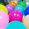 A collection of brightly colored matte latex balloons including yellow, orange, purple, pink, and blue.
