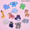 A collection of twelve random soft pastel animal fridge magnets including elephants, dinosaurs, and other cute creatures.