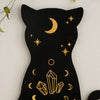 A black silhouette of a cat with gold star and crescent moon designs on a floating shelf.