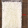 A clear plastic bag filled with white natural soy wax flakes for DIY candle making