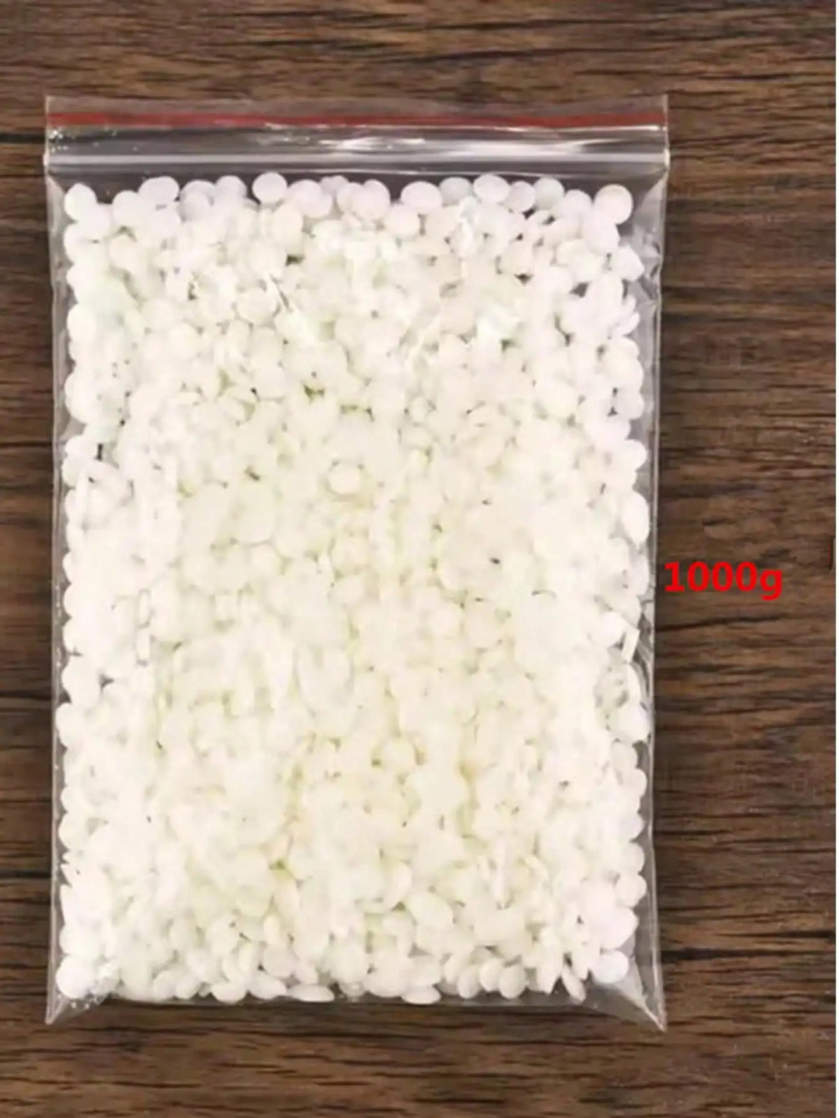 A clear plastic bag filled with white natural soy wax flakes for DIY candle making
