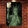 A vintage funny art parody metal tin sign featuring a green-toned depiction of a figure with a halo and rays, holding a roll 