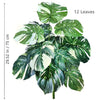 A vibrant artificial monstera plant with twelve large green and white silk leaves.