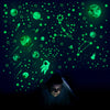 A person is looking at a dark background filled with glowing green stars and planets, suggesting glow in the dark wall decals
