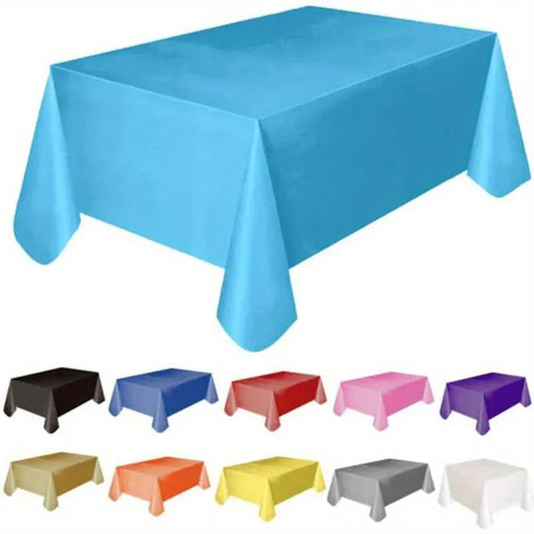 A collection of disposable solid color tablecloths in various shades including blue, red, pink, purple, and yellow.