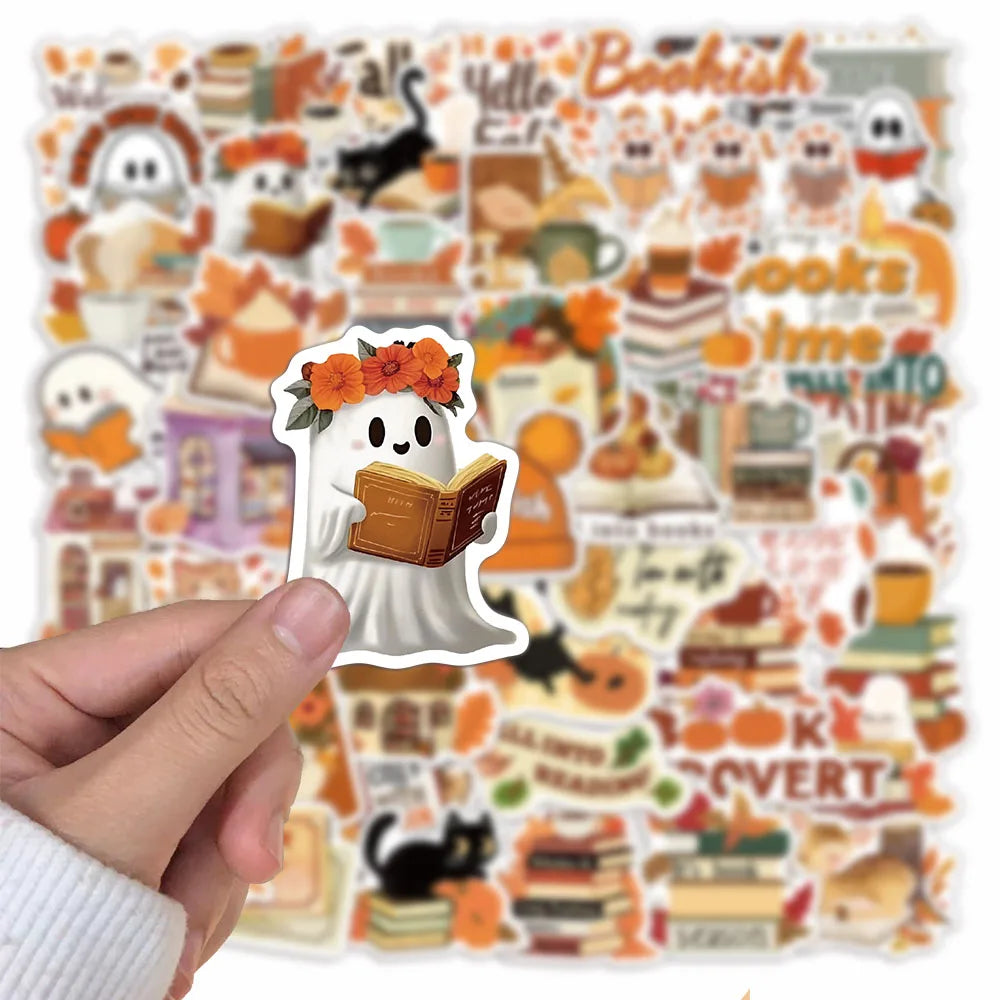 A hand holds a sheet of Bookish Autumn Graffiti stickers featuring cute ghost and book designs.