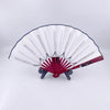 A white and red multi-mode LED party fan with pleated blades and a dark stand.