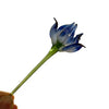 Handcrafted blue glass flower sculpture with a green stem and petals