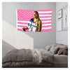 A pink and white American flag tapestry wall hanging featuring a woman in a sports jersey.