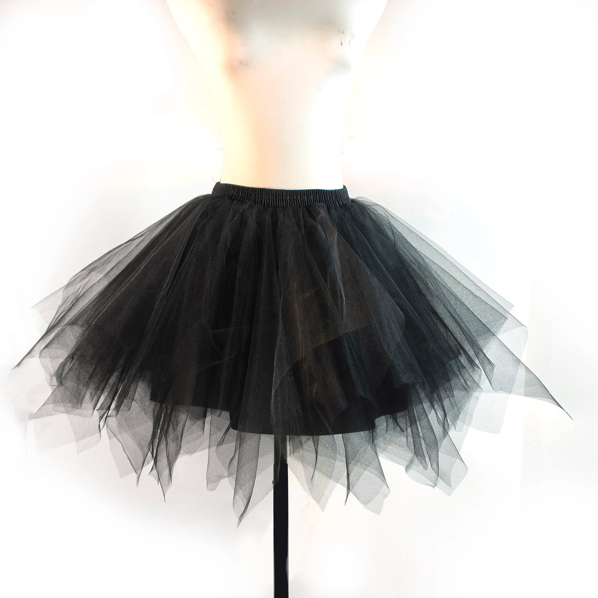 A black tulle tutu skirt displayed on a mannequin.