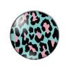 A round glass cabochon with a black and pink leopard print pattern.