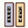 Two wooden photo strip frames with black and white portraits inside