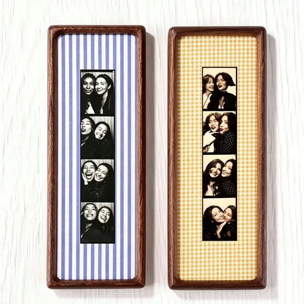 Two wooden photo strip frames with black and white portraits inside