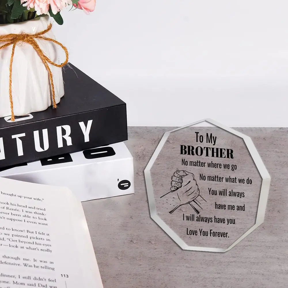 A clear acrylic desk plaque shaped like a fist bump for a brother with engraved text