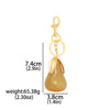 Gold pear-shaped fruit keychain charm with a lobster clasp