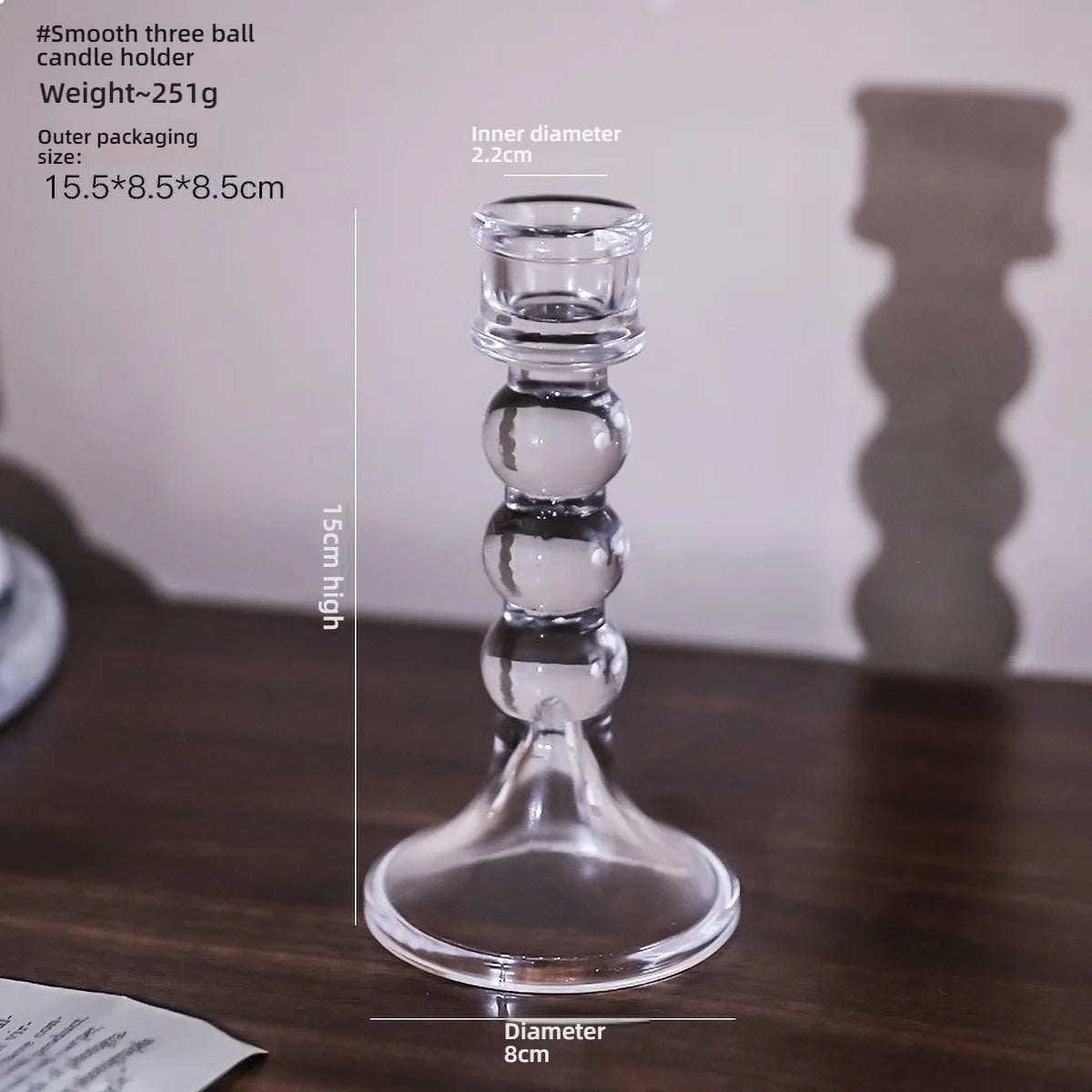 Elegant clear glass pillar candle holder with a wide base and stacked bulbous sections.