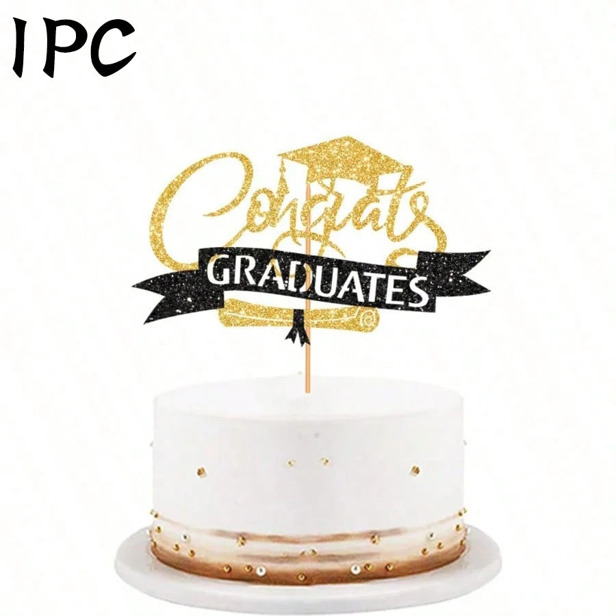 A white cake with a gold topper that reads Congrats Graduates