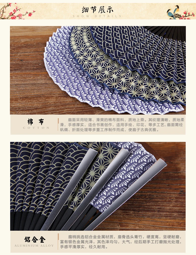 A close-up of a dark blue titanium alloy folding hand fan with intricate patterns.