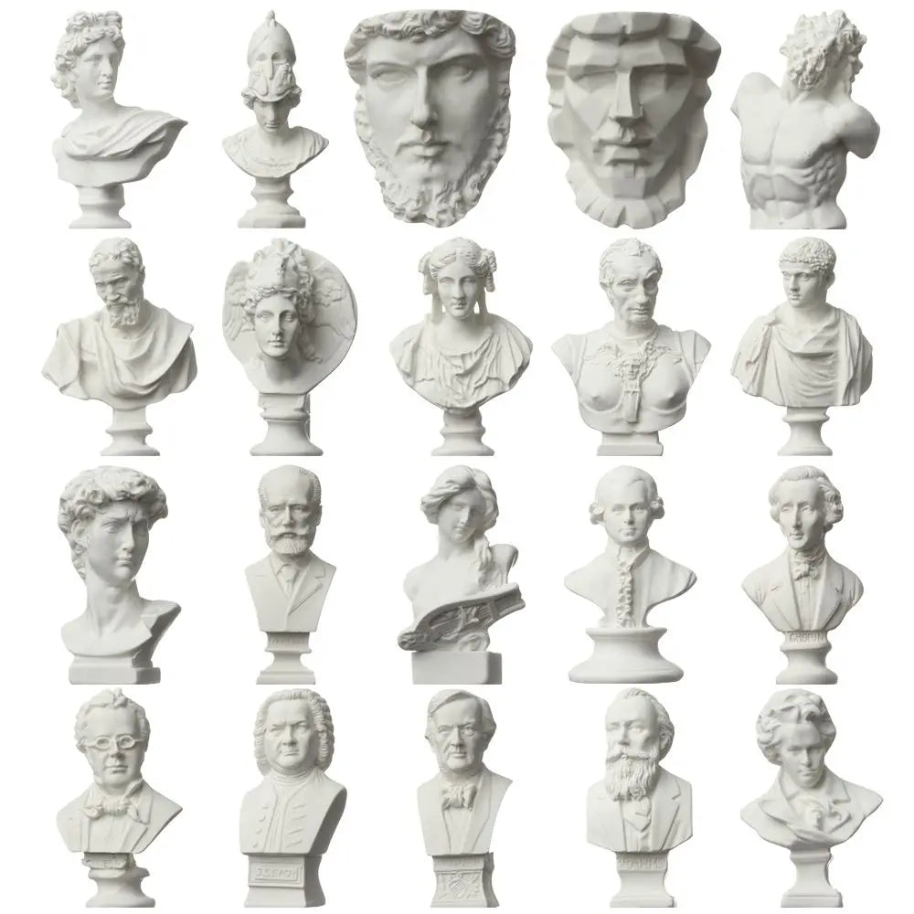 A collection of plaster bust miniatures depicting various classical figures and heads.
