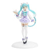 A PVC collectible figurine of Hatsune Miku in a purple and white outfit with teal hair.
