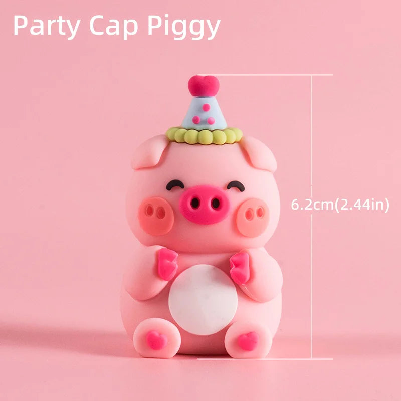 A pink piggy character cake topper with a conical party hat and a white belly.
