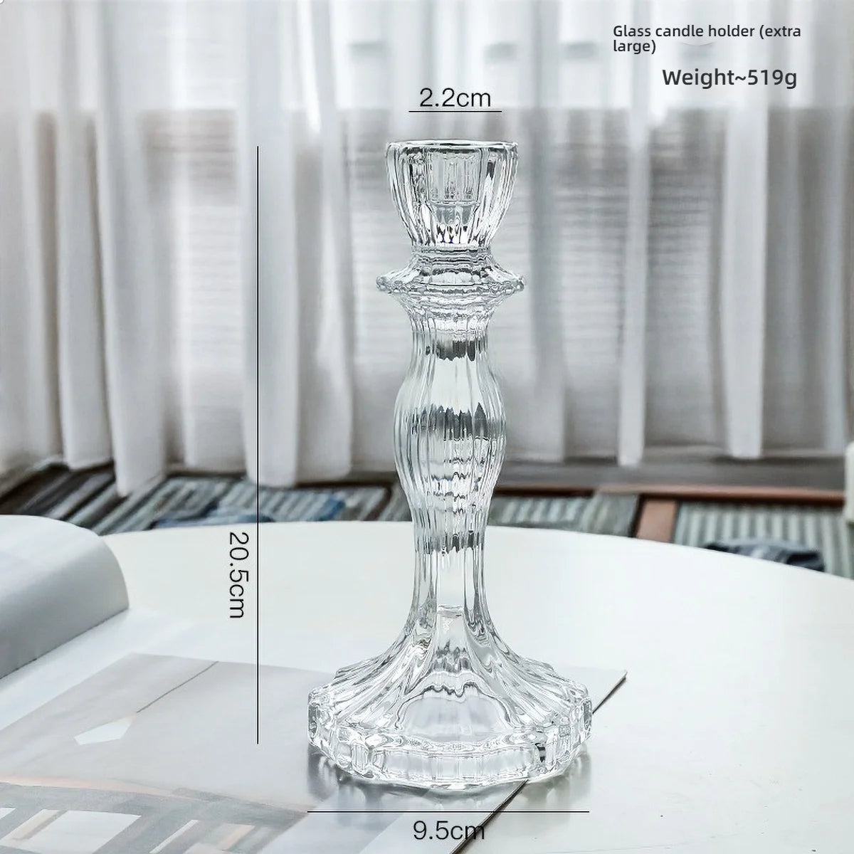 Elegant clear glass pillar candle holder with a flared base and pedestal design.