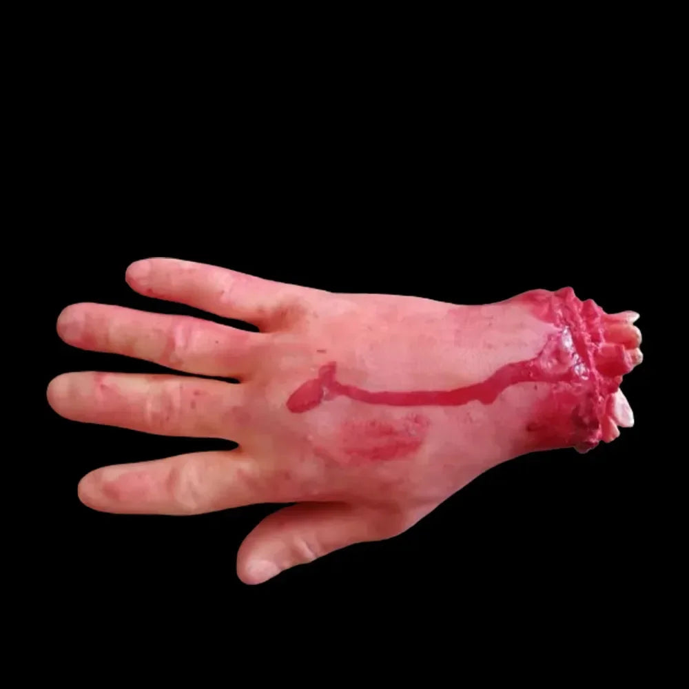 A pale, bloody hand prop used for Halloween haunted house decor.