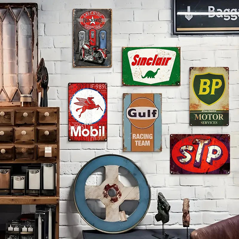 A collection of vintage metal tin signs and decor mounted on a white brick wall.