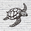 Black silhouette of a sea turtle on a white brick background.