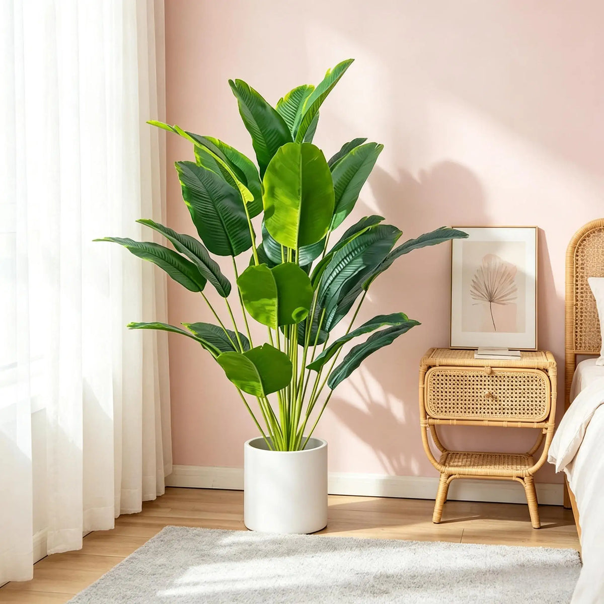 A vibrant green artificial Bird of Paradise plant in a white pot displayed indoors next to a wooden stool.