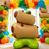 A stack of foil balloons shaped like a capybara and a turtle, used for party decoration.