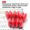 A set of ten red circular refrigerator magnets used for pinning items like postcards and photos.