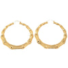 Pair of oversized bamboo hoop earrings in gold.