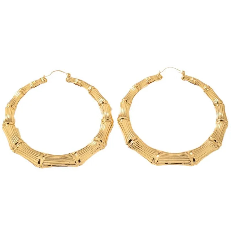 Pair of oversized bamboo hoop earrings in gold.