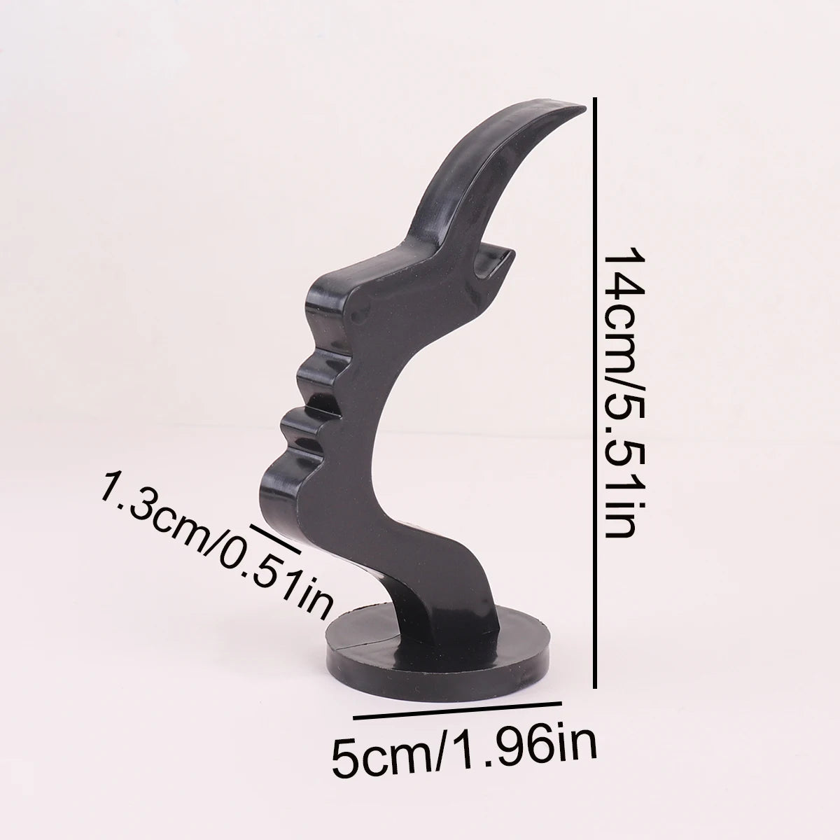 A black minimalist side face glasses holder with a curved design shown against a white background.