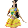 A handmade doll dress gown featuring a yellow bodice with floral patterns and a ruffled yellow skirt.