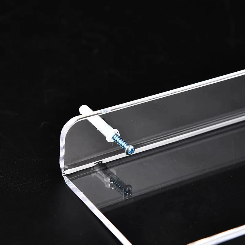 Clear acrylic floating shelf with wall mount displaying a small silver screw.